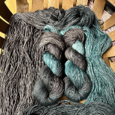 Variegated yarn in warm gray and pale sea green.