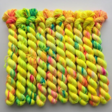 Bright yellow mini skeins with splashes of orange and green.