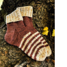 Socks are in coffee brown and speckled cream. Toe is cream, foot is stripes about three rows deep, and the rest of the body of the sock is brown. Ribbed foldover cuff is speckled cream.