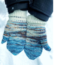 Colorwork mittens with three colors of yarn, ocean blue, a variegated gray and white that looks like mountains and white at the cuff. Colorwork is every other stitch rows periodically that contrast the current color in that section.