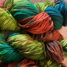 Variegated yarn in aqua, coral, spring green and dark green.