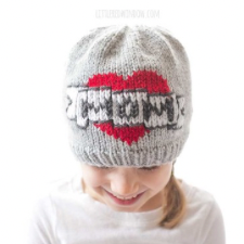 Hat with colorwork of heart with a ribbon that says Mom in the style of a traditional tattoo.
