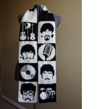 Scarf is done in alternating black and white squares. White squares have the Fab Four’s silhouettes. Black squares have their instruments.