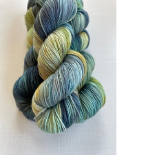 Variegated yarn in soft shades of blue with pale yellow and green.