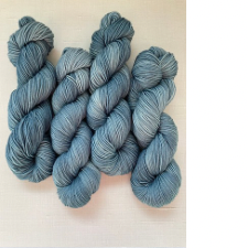 Twisted hanks of tonal yarn in medium blue-gray.